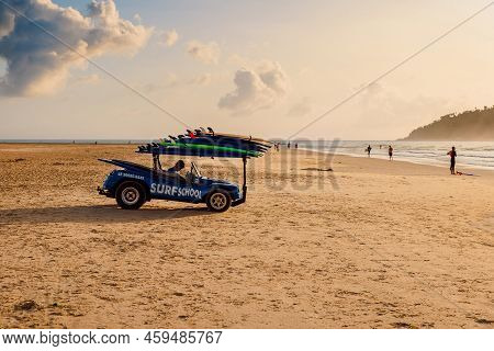 May 1, 2022. Florianopolis, Brazil. Holiday Beach With Car Of Surf School And Walking People On Ocea