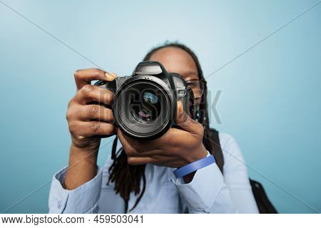 Amateur Photographer Taking Photos With Modern Dslr Device While Standing On Blue Background. Photog