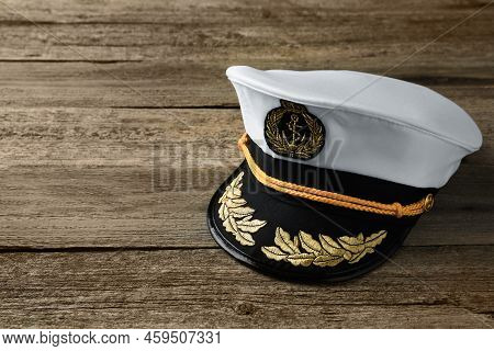 Peaked Cap With Accessories On Wooden Background, Space For Text