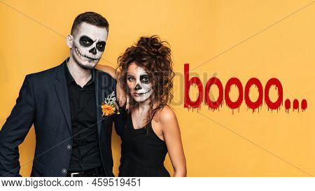 Halloween Celebration. A Studio Shot Of A Young Couple In Festive Halloween Costumes And With Makeup