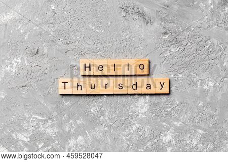 Hello Thursday Word Written On Wood Block. Hello Thursday Text On Cement Table For Your Desing, Conc