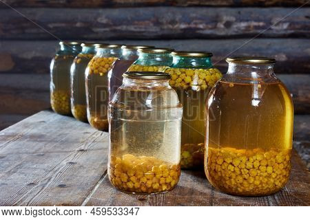 Cloudberry Home Canning, Jars Of Berry Compote Are On Table In Barn.