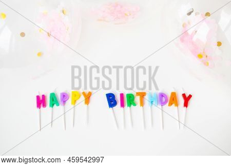 Colorful Candles With The Inscription Happy Birthday Isolated On A White Background Along With Confe