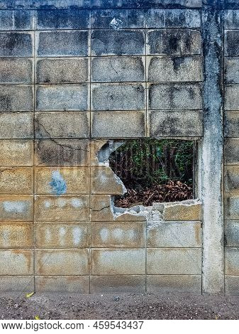 Dirty Old Eroded Cracked Plaster Cement Block Fence. Concrete Block Wall. Destroyed Crumbling Cement