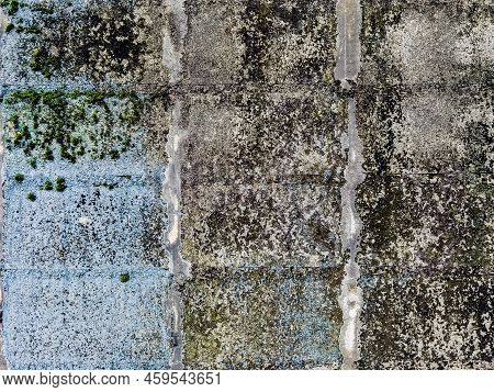 Dirty Old Eroded Cracked Plaster Cement Block Fence. Concrete Block Wall. Destroyed Crumbling Cement
