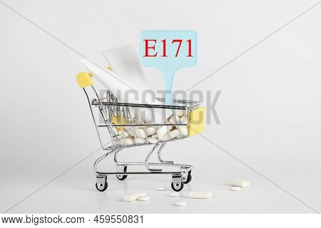 Titanium Dioxide, E171, Dangerous Additive Concept. Gum, Pills, Toothpaste, Cream In Basket And Sign
