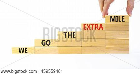 We Go The Extra Mile Symbol. Wooden Blocks With Words We Go The Extra Mile. Beautiful White Backgrou
