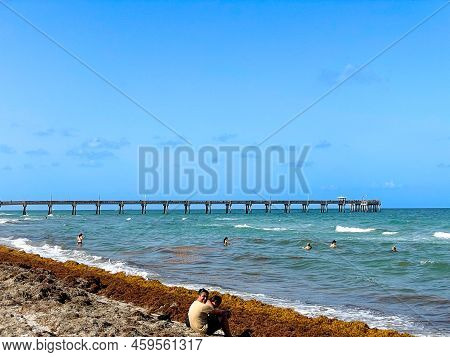 Dania Beach, Fl - Usa July 27, 2022 Landscape View Of Dania Beach Ocean Park Pier And Swimmers On Th