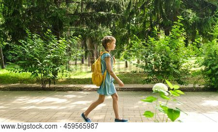 Back To School. Kid Elementary School Student Walks Through The Park To School On First Day Of Fall.