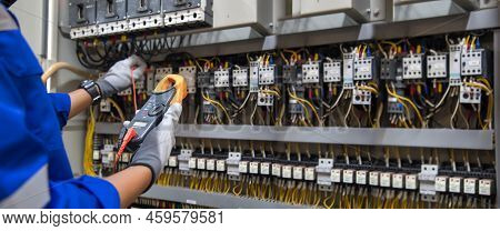 Electricity And Electrical Maintenance Service, Engineer Hand Holding Ac Voltmeter Checking Electric
