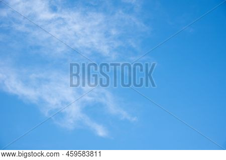 Blue Sky Background With White Fluffy Cumulus Clouds. Panorama Of White Fluffy Clouds In The Blue Sk