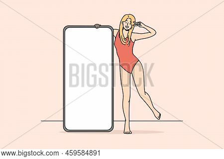 Smiling Woman In Swimsuit Posing With Cellphone With Mockup Screen. Happy Girl In Bodysuit Near Smar