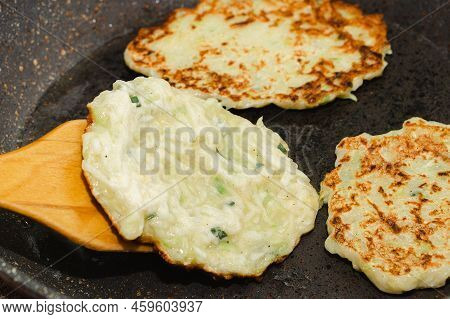 Recipe For Zucchini Fritters. Step 5 - Fry Pancakes In Pan Until Golden Brown. Flipping Pancakes Wit