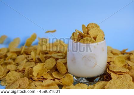 Side View Of Corn Flakes In A Glass Of Milk