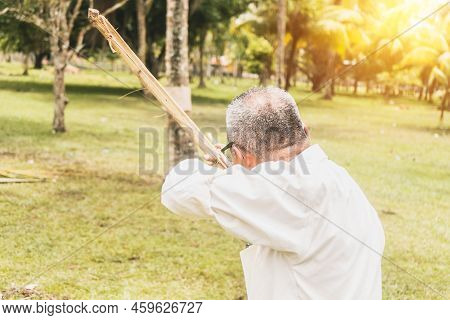 Old Man From Nicaragua, Central America, Aiming At A Target With A Bow And Arrow