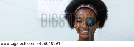 Young Woman African American Using Occluder For Eye Test Ophthalmological In Optics Clinic. Woman Ch