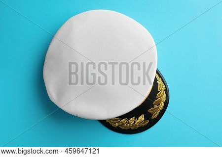 Peaked Cap With Accessories On Light Blue Background, Top View