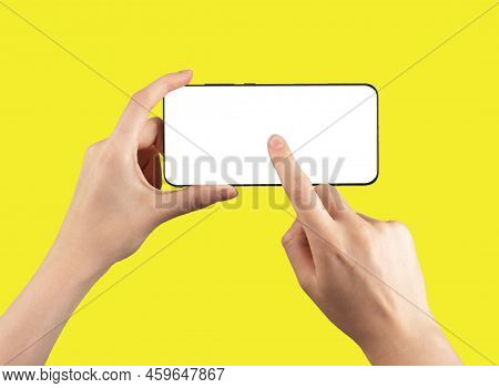 Forefinger Clicking Play To Start Video At Phone Mockup On Yellow Background. Woman Holding Smartpho