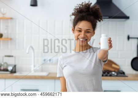 Happy Young Woman Holding Bottle Of Dietary Supplements Or Vitamins In Her Hands Healthy Lifestyle