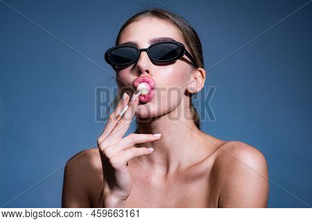 Sexy Woman Face. Sweet Bite. Young Sexy Model. Beautiful Mouth With Glossy Lips Biting A Colorful Lo