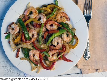 Sauteed Shrimp Served With Sauteed Onons And Peppers,
