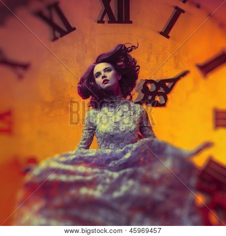 Young woman on clock background.