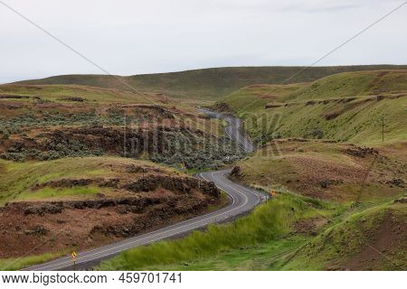 Scenic Road In The Countryside By Green Farm Fields. Near Washtucna, Washington, United States.