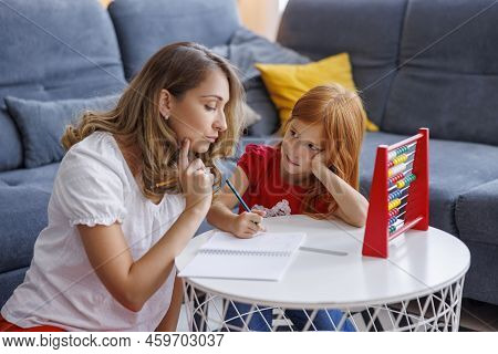 Mother Helping Daughter With School Project And Homework, Studying Math, Practicing Summation And Su