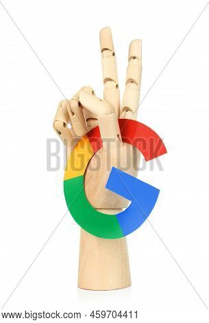 Kiev, Ukraine - May 04, 2022: Wooden Hand Holds Google Paper Logo And Show Victory Gesture, On White