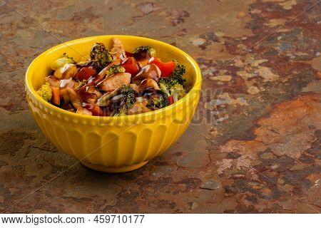 Chicken Yakissoba In Yellow Bowl On Rusty Slate