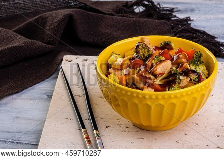 Chicken Yakisoba In Yellow Bowl Over Travertine Marble Stone