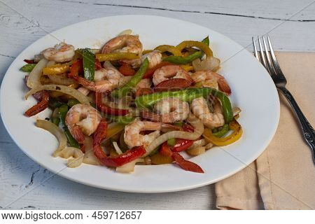 Sauteed Shrimp Served With Sauteed Onons And Peppers,