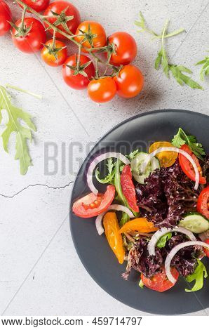Healthy Vegetable Salad With Fresh Salad Leaves, Arugula, Cherry Tomato, Cucomber And Parsley In Pla