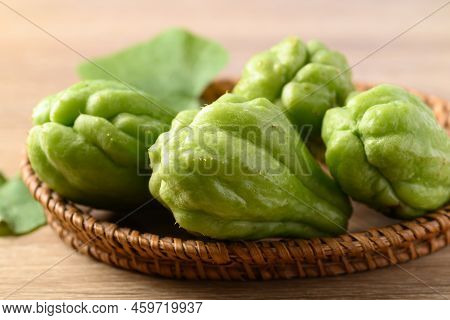 Chayote Squash Fruit In Basket On Wooden Table, Organic Vegetables