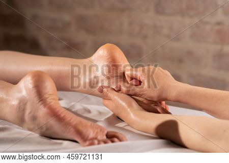 Foot Massage, Young Woman Having Feet Massage In Beauty Salon, Close Up View. Reflexology Techniques