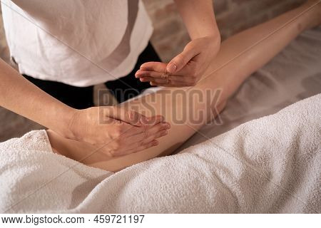 Masseur Makes Anti-cellulite Massage On The Legs And Thighs Of Patient. Treatment Of Excess Weight.