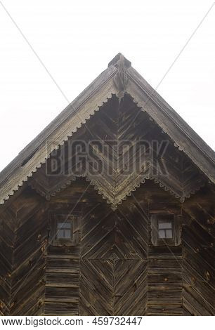 Fronton Of An Old Wooden House. Decorated With Wood Carvings. Exterior Details. Close-up.