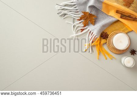 Autumn Aesthetic Concept. Top View Photo Of Scarf Candles On Rattan Serving Mat Cinnamon Sticks Anis