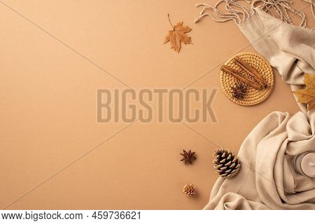 Autumn Mood Concept. Top View Photo Of Cinnamon Sticks Anise On Rattan Serving Mat Yellow Maple Leav