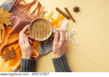 Autumn Aesthetic Concept. First Person Top View Photo Of Female Hands In Knitted Jumper Holding Cup 