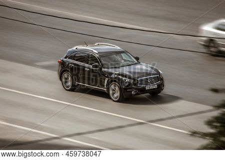 Fast Moving Black Infiniti Fx50 Car On Highway Road. Overspeed In City Concept. Suv Car On City Road