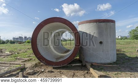 Reinforced Concrete Storm Sewer Pipes Of Large Diameter Stacked At A Construction Site. Sewer Large 