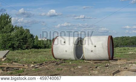Reinforced Concrete Storm Sewer Pipes Of Large Diameter Stacked At A Construction Site. Sewer Large 