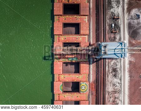 Bulk Carrier Ship Unloading Cargo At A Port Depot