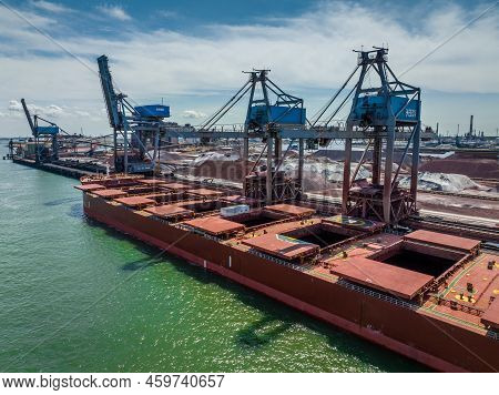 Bulk Carrier Ship Unloading Cargo At A Port Depot