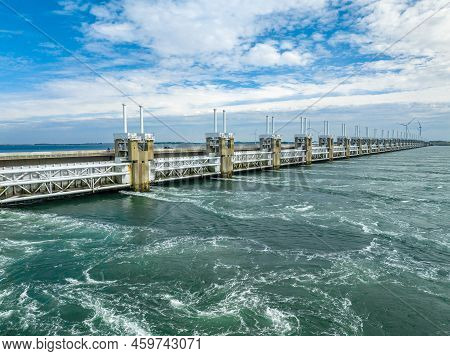 Water Rushing Through A Storm Surge Barrier In The Netherlands