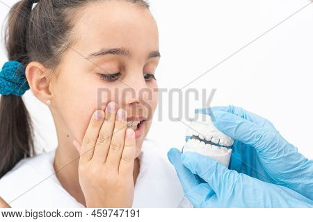 Dentist Is Check And Set Dimension Of Brackets. Talking To Girl About Braces In Her Mouth