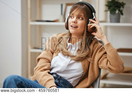 Dreaming Young Blonde Student Lady Freelancer In Warm Sweater In Headphones Listen Fav Songs Looks A