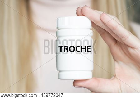 Troche Word On The Label Of A White Can In The Hands Of A Doctor's Girl, A Medical Concept