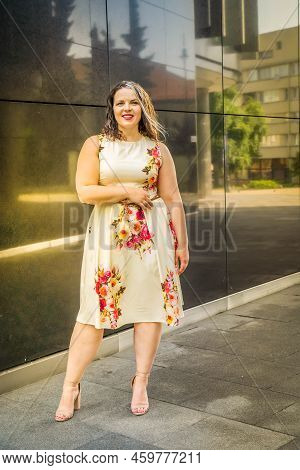 Full Lenth Portrait Of 40s Plus Size Woman With Grey Hair Standing Outdoor In A City